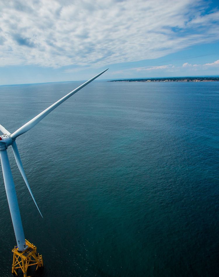 Wind turbine over a large body of water.