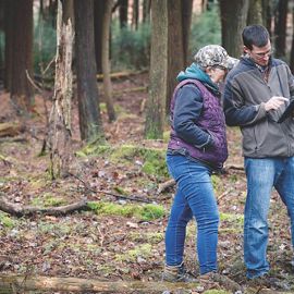 two people talking in a forest.