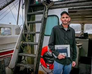 Photo of commercial fisherman Kurt Martin on his boat docked in Massachusetts.