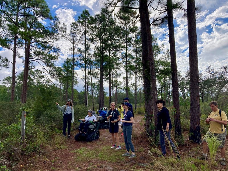Volunteers trying track chairs in Tiger Creek Preserve to improve the trails accessibility.